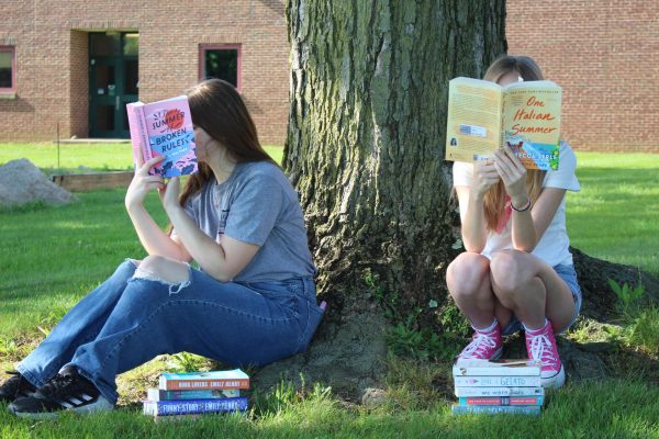 Hannah Stoner (left) and Sophia Kuzmenko (right) enjoy the warm air with some of the best books of the summer. 