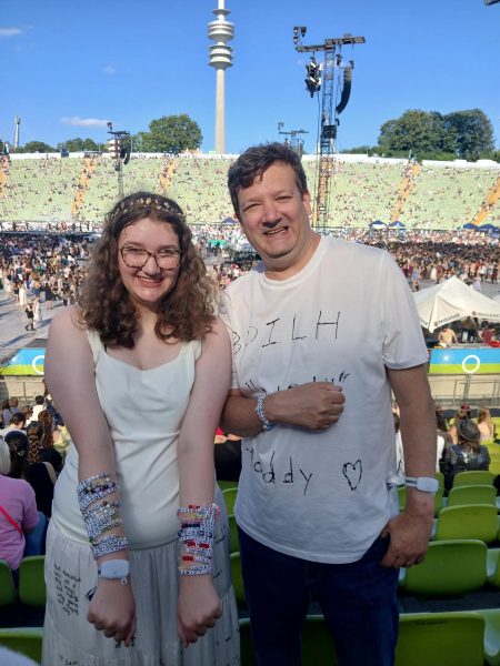 Sophie Haque and her father show off their friendship bracelets as they stand in the Munich stadium