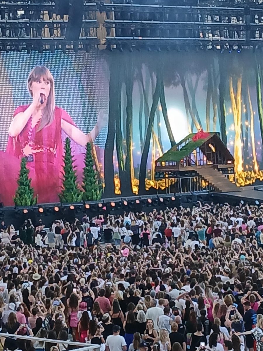 Swift sings "cardigan" on the rooftop of a cabin